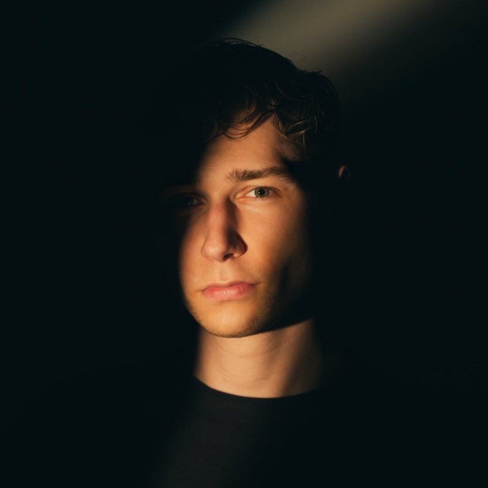 Felix Buchholz, lit by a single strip of light